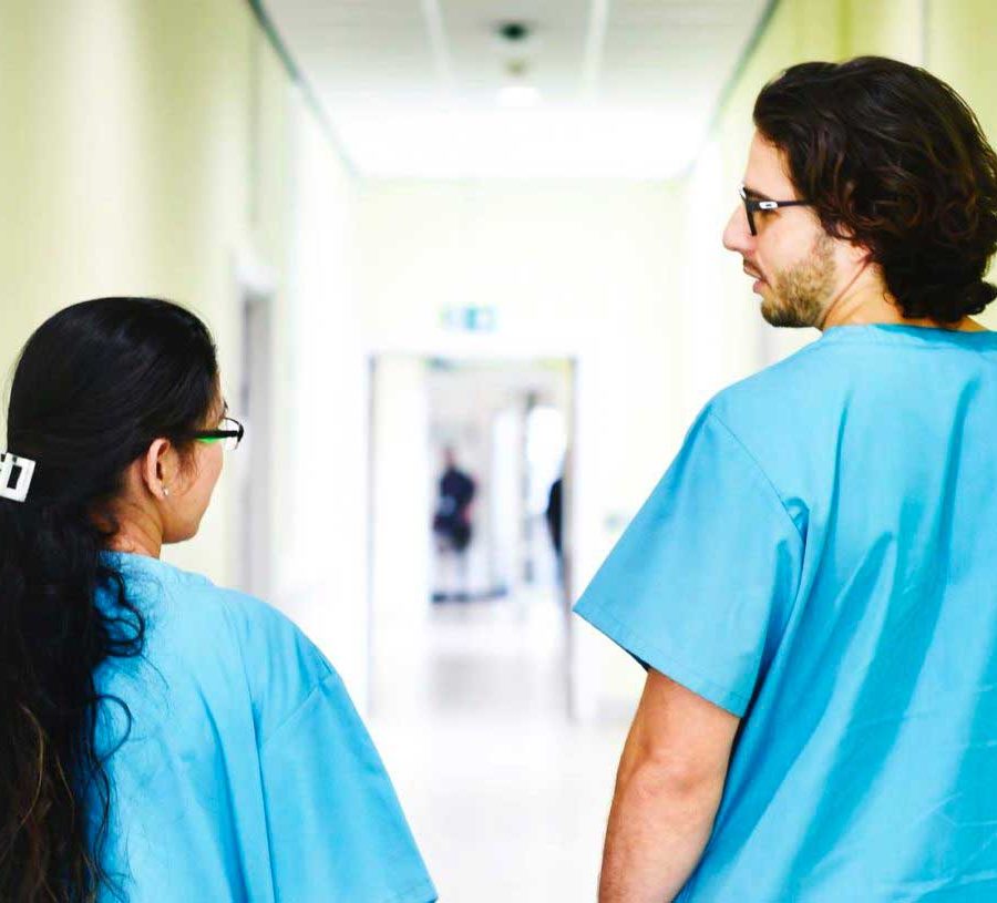 Two nurses in hospital corridor